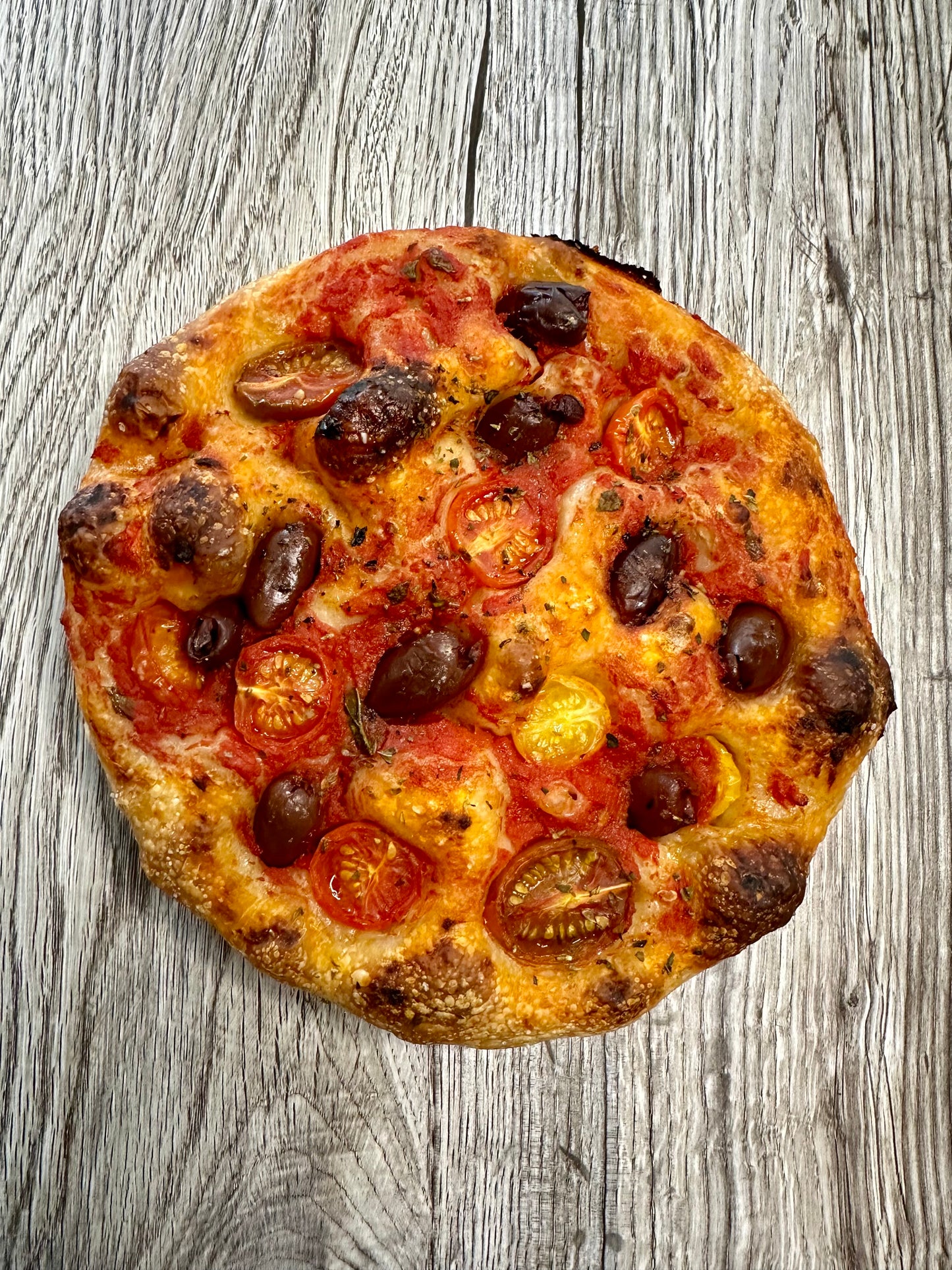 Focaccia Olive Pomodorini, e Origano Siciliano. “ focaccia with Tomatoes, Olives, and Sicilian origano.